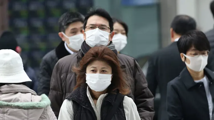 Japan bans new entries of foreigners after virus variant arrives