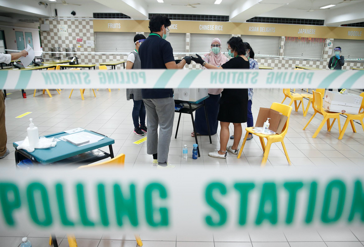 In masks and gloves, Singaporeans vote under COVID-19 cloud