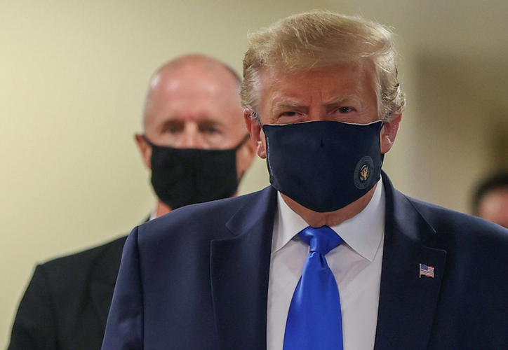In a first, Trump dons mask in visit to a military medical facility