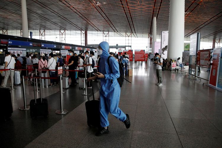 Beijing cuts flights to curb potential spread of mounting coronavirus cases