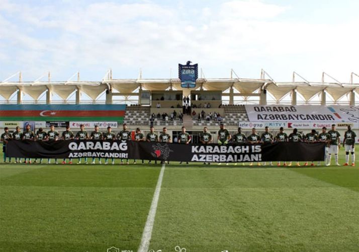 Neftchi and Sabah came out onto ground with special placard
