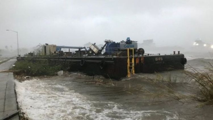 Slow-moving storm Sally batters boats and bridges