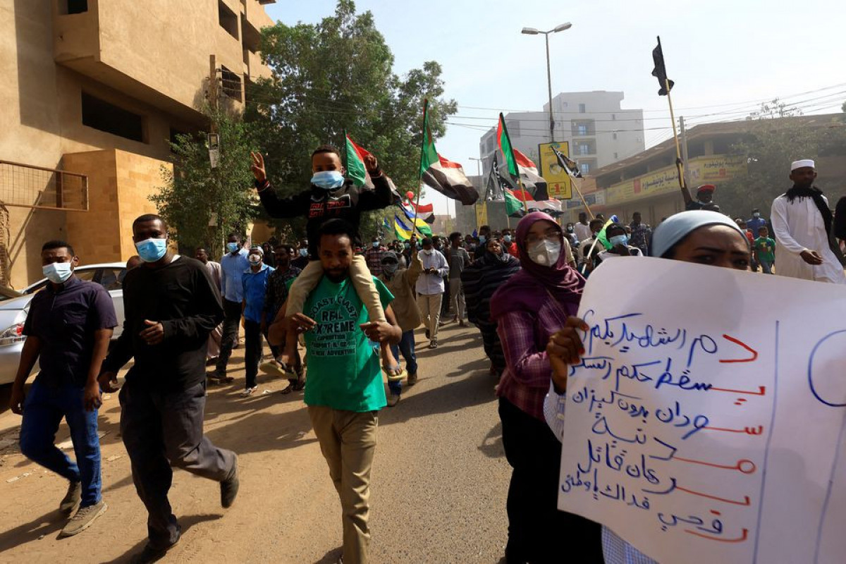 People march to the presidential palace, protesting against military rule following last month's coup in Khartoum, Sudan December 19, 2021.
