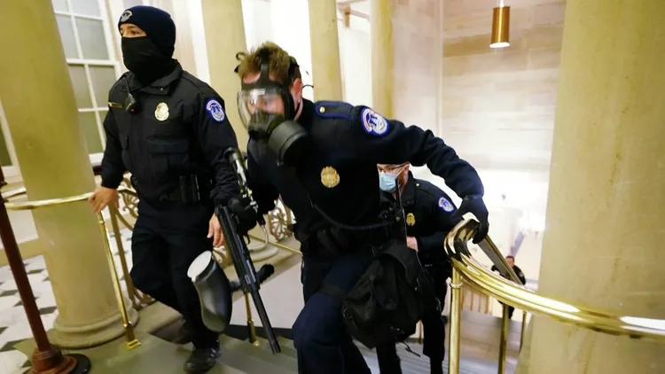 Multiple police officers were seen being evacuated with injuries after clashes with pro-Trump rioters on Capitol Hill
