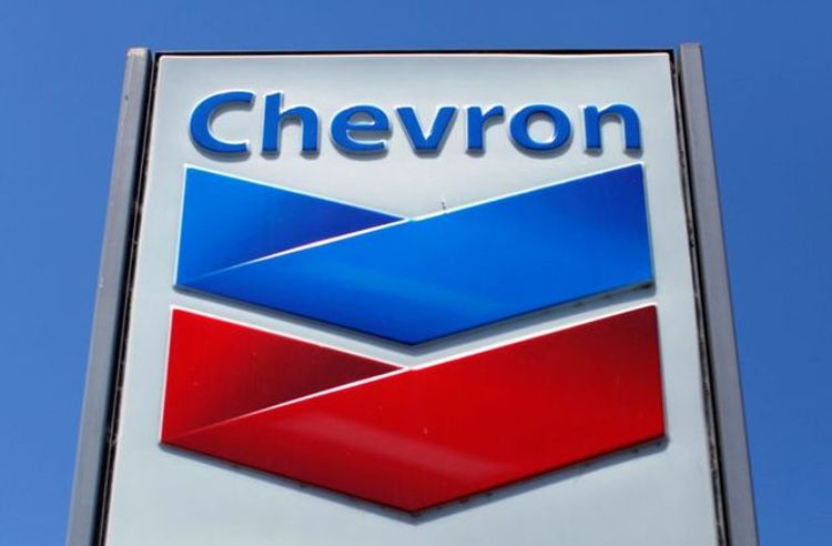 Chevron vows to slow carbon emissions, raise oil output with modest spending