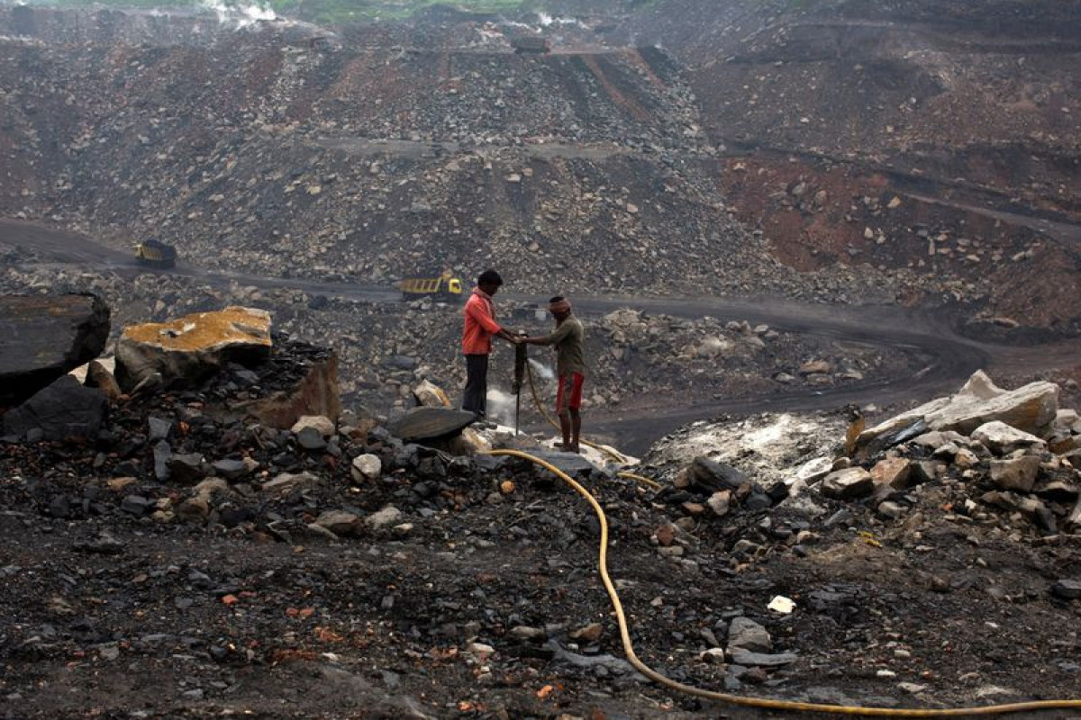 Workers drill at an open cast coal field at Dhanbad district in the eastern Indian state of Jharkhand