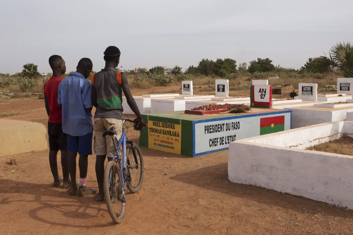 Boys stand next to the grave of former president Thomas Sankara in Ouagadougou, Burkina Faso