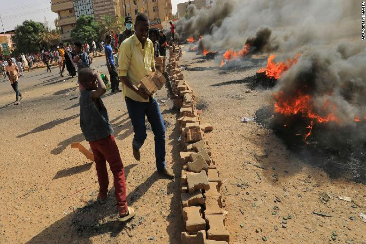 Crowds rally as Sudan PM held in apparent army coup; gunfire reported