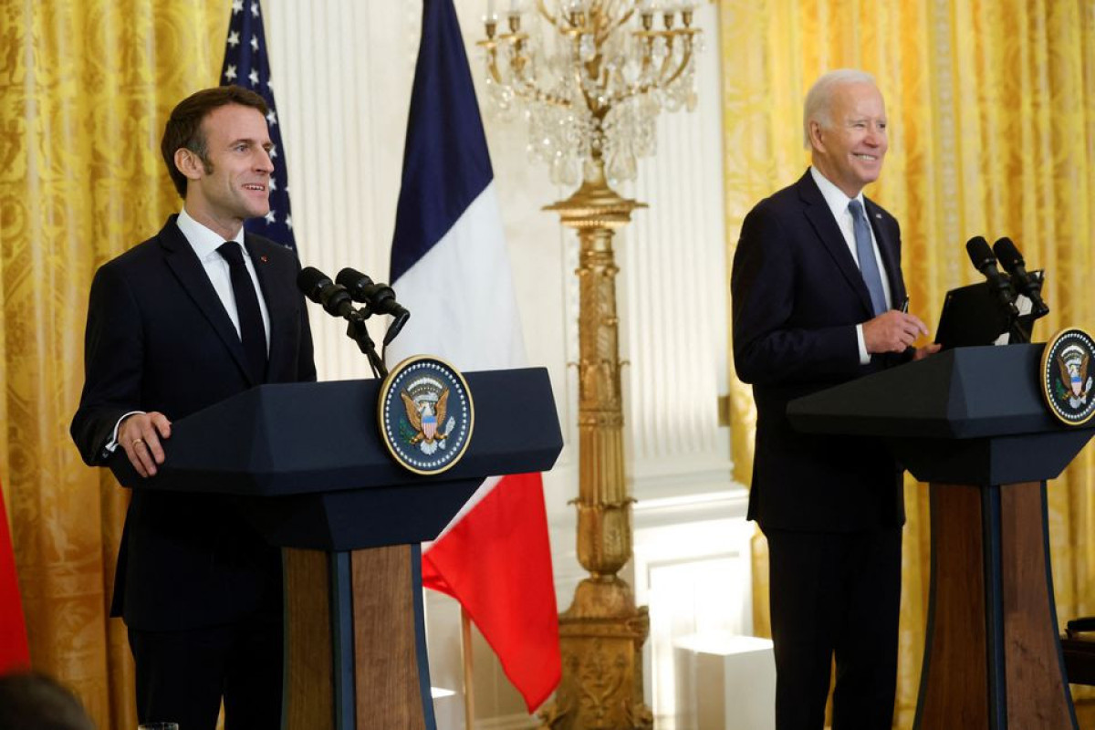French President Emmanuel Macron and U.S. President Joe Biden hold a joint news conference in the East Room of the White House in Washington, U.S., December 1, 2022.