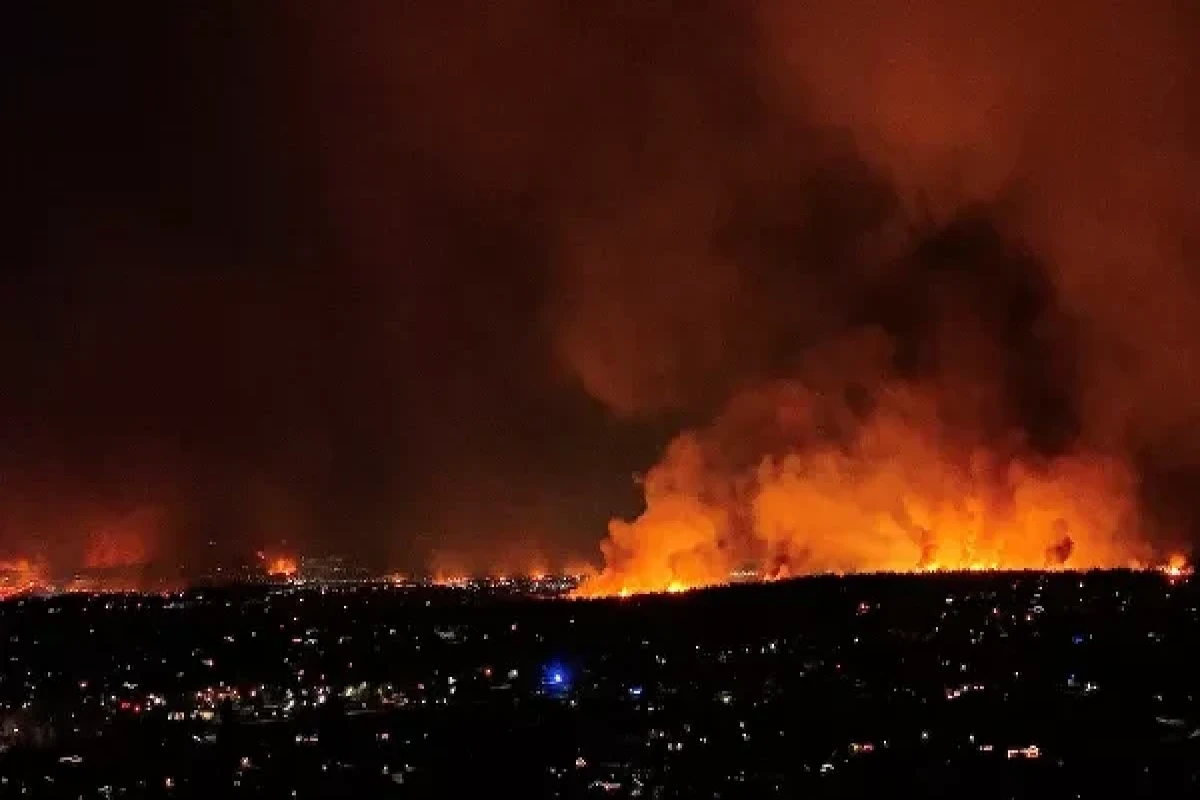 A general view shows wind-driven grass fires burning in Superior, Colorado, US, 30 December 2021 in this screen grab taken from drone footage obtained from social media. Video taken with a drone 30 December 2021.