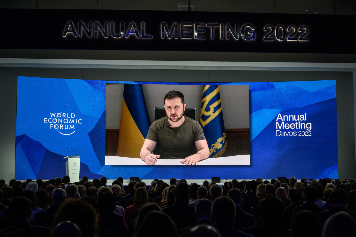 Ukrainian President Volodymyr Zelensky seen on a giant screen by video link delivering remarks at the Congress centre during the World Economic Forum (WEF) annual meeting in Davos, Switzerland, on May 23