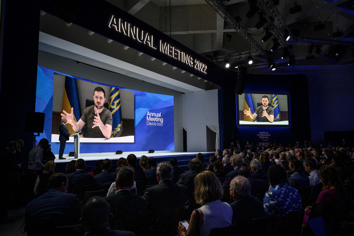 Ukrainian President Volodymyr Zelensky is seen on a giant screen during his address by video conference as part of the World Economic Forum (WEF) annual meeting in Davos, Switzerland, on May 23