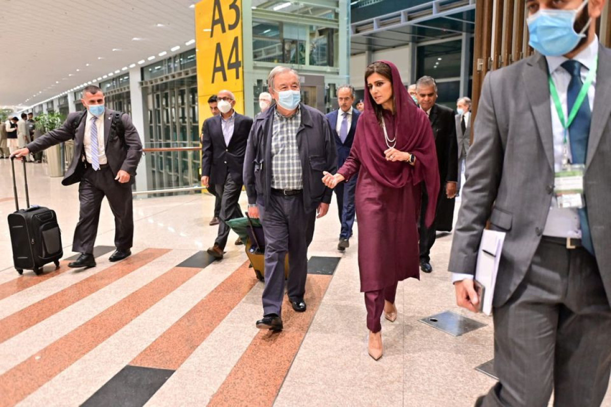 Antonio Guterres, United Nations Secretary General, walks with Pakistan's Minister of State for Foreign Affairs Hina Rabbani Khar, upon his arrival at the Islamabad International Airport in Islamabad