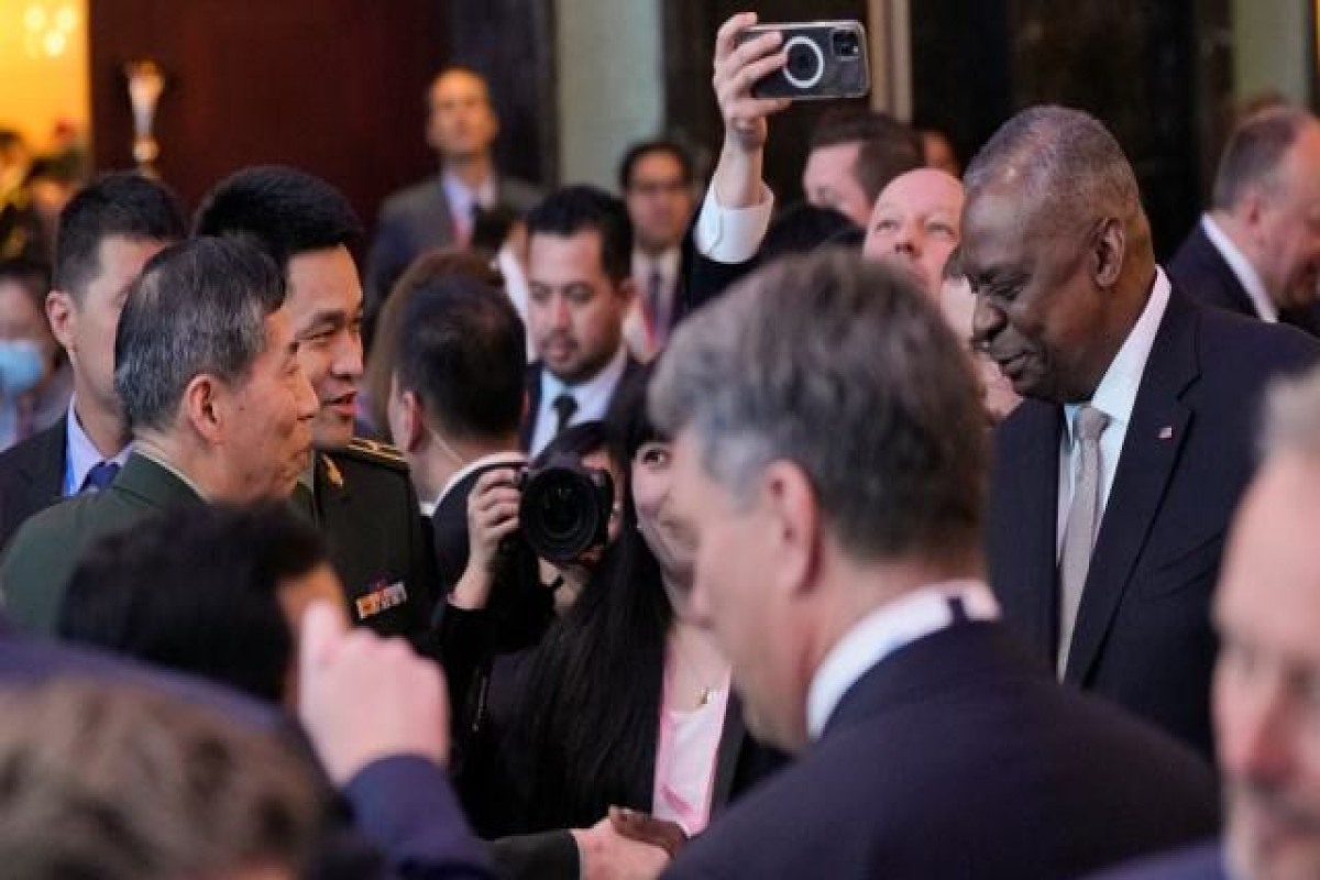 US, Chinese defense chiefs speak briefly after Beijing rejected meeting request